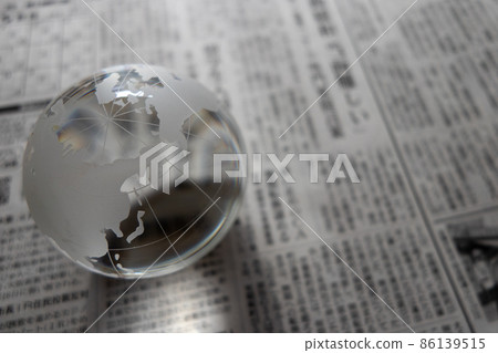 Glass globe and newspaper Global news and current affairs image Glass globe and newspaper Global news and current affairs image 86139515
