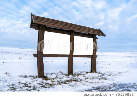 Blank outdoor wooden billboard on a winter landscape 86139858