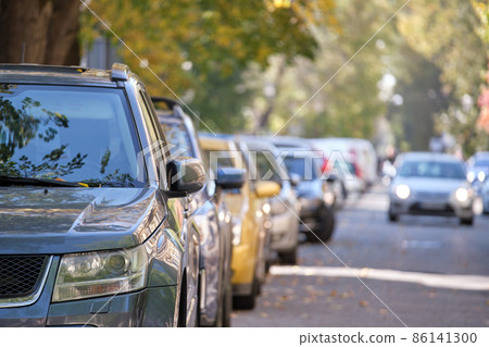 City traffic with many cars parked in line on street side 86141300