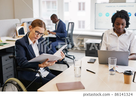 Businesswoman using Wheelchair in Meeting 86141324