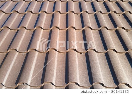 Closeup of house roof top covered with metallic shingles Closeup of house roof top covered with metallic shingles 86141385