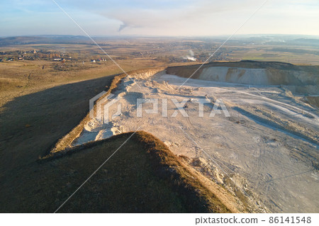 Aerial view of open pit mine of sandstone materials for construction industry with excavators and dump trucks. Heavy equipment in mining and production of useful minerals concept 86141548