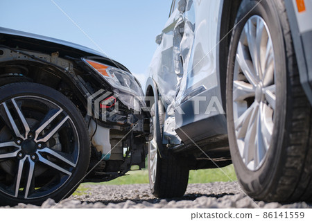 Damaged in heavy car accident vehicles after collision on city street crash site. Road safety and insurance concept Damaged in heavy car accident vehicles after collision on city street crash site. Road safety and insurance concept 86141559