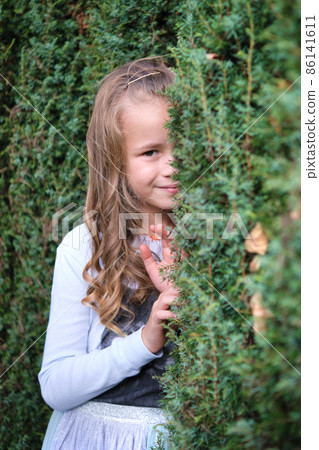 Portrait of pretty child girl outdoors 86141611