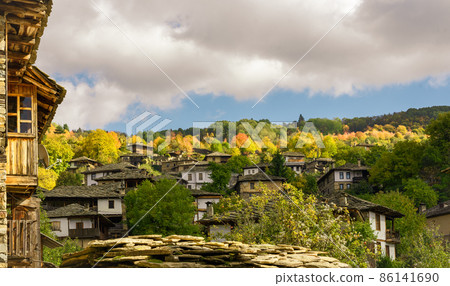 Old traditional Bulgarian house in mountain village of Kovachevitsa. Traditional slan stone roofs Old traditional Bulgarian house in mountain village of Kovachevitsa. Traditional slan stone roofs 86141690
