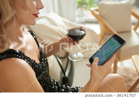 Woman Checking Taxi App 86141707
