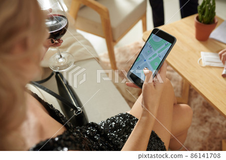 Woman Checking Taxi Application Woman Checking Taxi Application 86141708