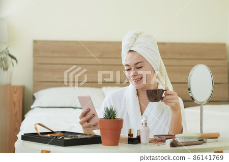 Smiling Woman Checking Phone Smiling Woman Checking Phone 86141769