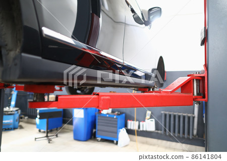 Car is on lift in car service closeup 86141804