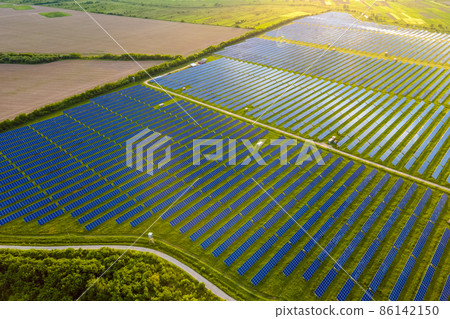 Aerial view of large sustainable electrical power plant with many rows of solar photovoltaic panels for producing clean ecological electric energy. Renewable electricity with zero emission concept. 86142150
