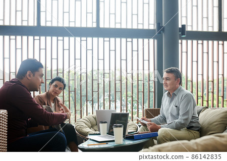 Business People Looking at Talking Colleague 86142835