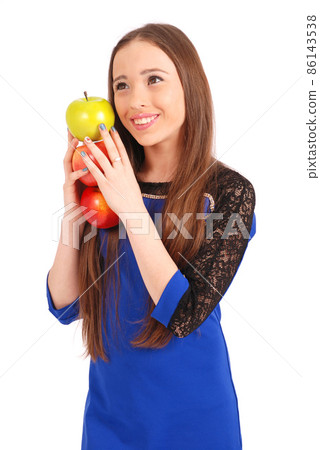 Young smiling brunette girl holding three apples 86143538