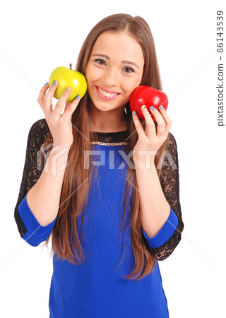 Young girl holds near the face apples Young girl holds near the face apples 86143539