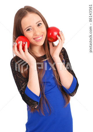 Young girl holds near the face apples 86143561
