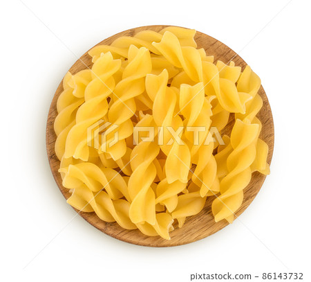 raw Fusilli pasta in wooden bowl isolated on white background with clipping path and full depth of field. Top view. Flat lay 86143732