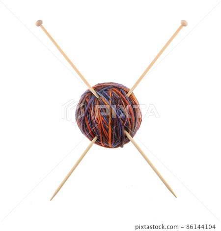 Ball of wool and knitting needles making a cross Ball of wool and knitting needles making a cross 86144104