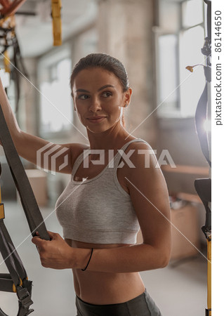 Young female athlete exercising in fitness club 86144650