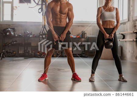 Shot of fitness couple having workout session at gym Shot of fitness couple having workout session at gym 86144661