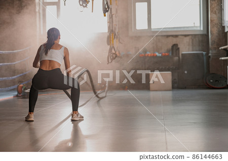 Young woman performing functional training in gym 86144663