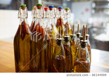 Classic ukrainian alcohol tincture with hot chilli pepper. Strong alcohol. Alcohol-based natural remedy for stimulating growth concept. 86144999