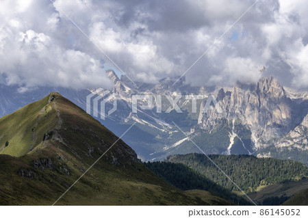 Dolomite peaks in the clouds. View from the Lino-Pederiva trail. Dolomite peaks in the clouds. View from the Lino-Pederiva trail. 86145052