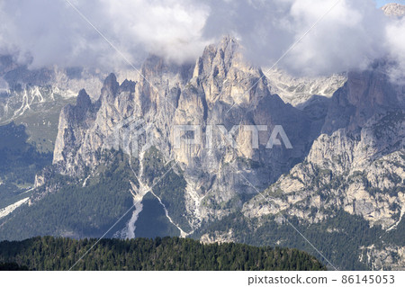 Dolomite peaks in the clouds. View from the Lino-Pederiva trail. Dolomite peaks in the clouds. View from the Lino-Pederiva trail. 86145053