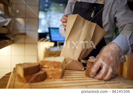 Bakery, bread in paper bag on rustic wood background, grocery concept. 86145306
