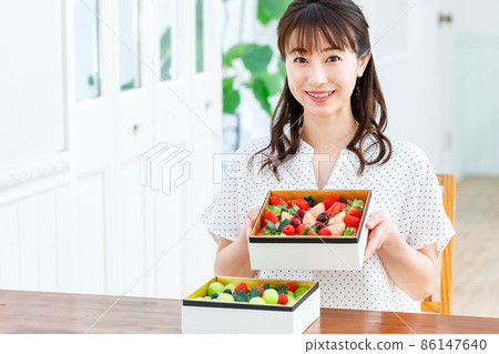 Female with an assortment of fruits 86147640