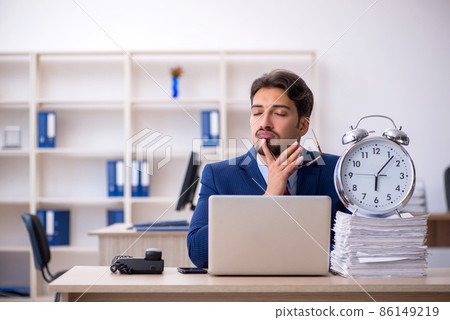 Young businessman employee and too much work in the office Young businessman employee and too much work in the office 86149219