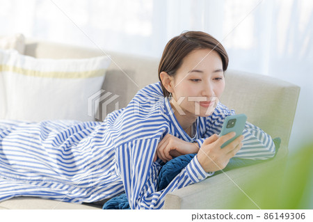 Sofa relaxing female in her 30s Sofa relaxing female in her 30s 86149306