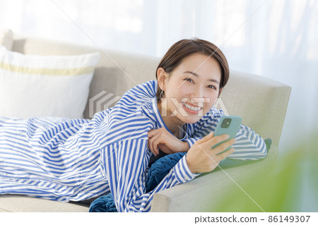 Sofa relaxing female in her 30s Sofa relaxing female in her 30s 86149307