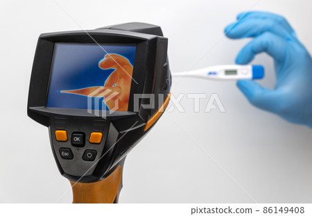 hand with a thermometer is displayed on the thermal imager screen. selective focus. hand with a thermometer is displayed on the thermal imager screen. selective focus. 86149408