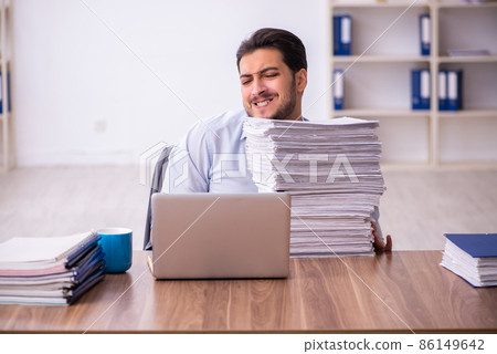 Young businessman employee unhappy with excessive work in the office 86149642