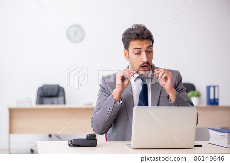 Young male employee working in the office 86149646