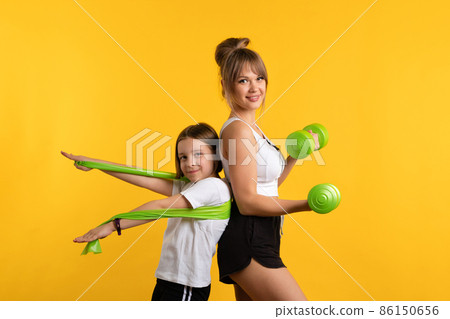 Mom and daughter workouts in studio 86150656