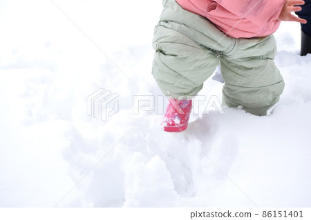 A girl walking in the snow A girl walking in the snow 86151401