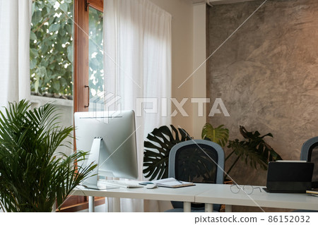 Wooden work desk with pc computer and documents, books, modern interior of cozy cabinet, table for businessman or student at home, comfortable workspace, workplace with computer in apartment. 86152032