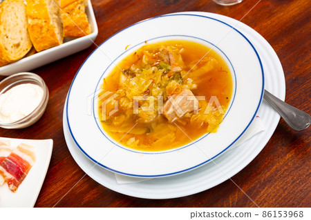Thick cabbage soup shchi with pork cooked in mushroom broth Thick cabbage soup shchi with pork cooked in mushroom broth 86153968