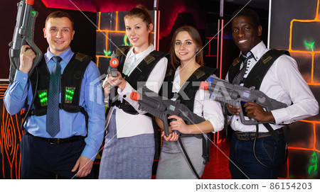 males and females in business suits posing at laser tag room males and females in business suits posing at laser tag room 86154203