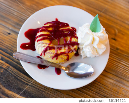 Cookie with ice-cream and berry jam served on table 86154321