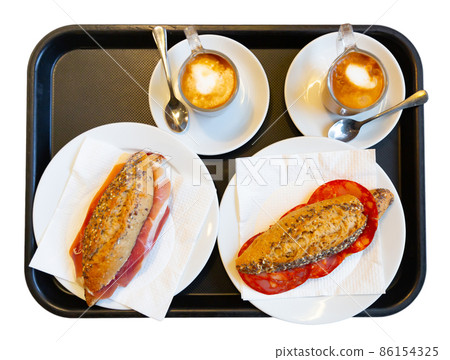 Mini sandwiches and mugs of ground coffee 86154325