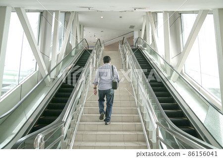 Man going up the stairs inside a subway station. 86156041