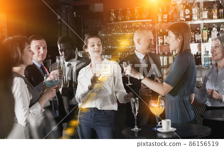 Young women enjoying corporate party Young women enjoying corporate party 86156519