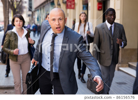 Portrait of hurrying man 86156576