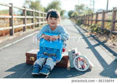 Girl holding a school bag First grade 86158644