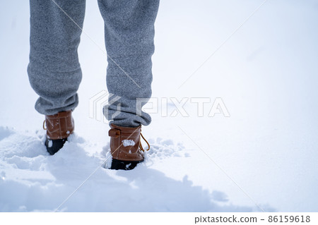 Walking on a snowy road (snow shoes) Walking on a snowy road (snow shoes) 86159618