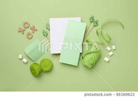 Valentine's Day accessories on green background, top view 86160622