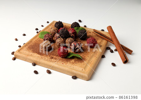 Concept of sweets with chocolate candies on white background Concept of sweets with chocolate candies on white background 86161398