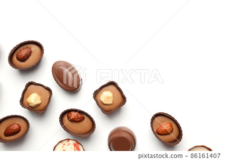 Flat lay composition with chocolate candies on white background 86161407