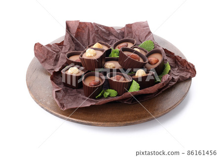Concept of sweets with chocolate candies isolated on white background Concept of sweets with chocolate candies isolated on white background 86161456